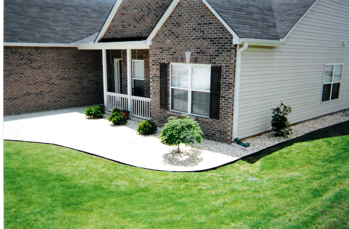 Landscaping with river rock and edging in Stockbridge, GA